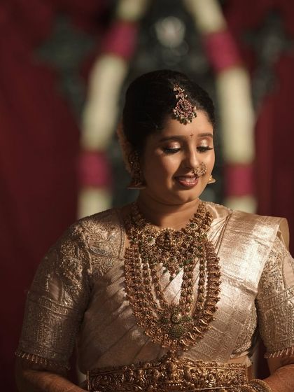 A candid shot capturing the bride's gentle smile. The soft-focus makeup look is both romantic and timeless.