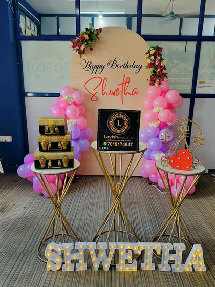 A focused shot on the central arrangement, highlighting the custom backdrop, our branding, and the glowing marquee letters on the floor.