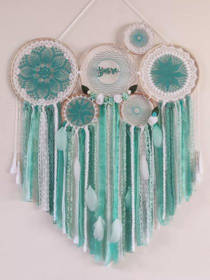 Add some minty freshness to your home. This custom cluster dreamcatcher for 'Yusra' uses sea green tones to create a soothing and serene atmosphere.