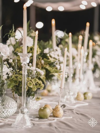 A close-up of the candlelit tablescape, with the focus on the beautiful reflections and soft light.