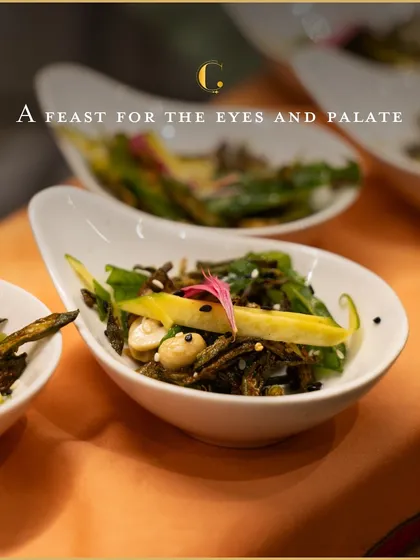 A closer look at our crispy okra and raw mango salad. It's a feast for the eyes and palate, showcasing our ability to create innovative vegetarian dishes.