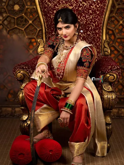 A close-up variation of the Sreeleela warrior concept, focusing on her expression and the exquisite details of her makeup and jewelry.