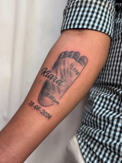 A slightly different angle of the baby footprint tattoo.