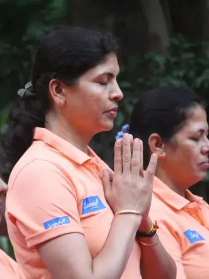 A close-up of students in a moment of quiet reflection and prayer during our Yoga Day event. It captures the peaceful and spiritual side of our community practice.