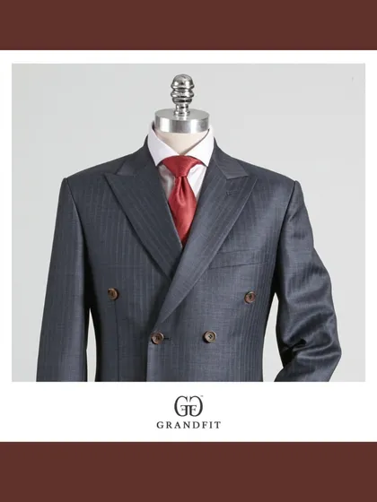 A detailed view of the grey double-breasted jacket, focusing on the subtle texture of the fabric and the precision of the lapel construction.