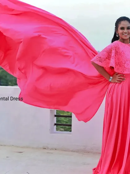 Make a bold statement with this vibrant pink maternity gown. The long, flowing trail adds a touch of drama and is perfect for creating breathtaking, memorable photos.