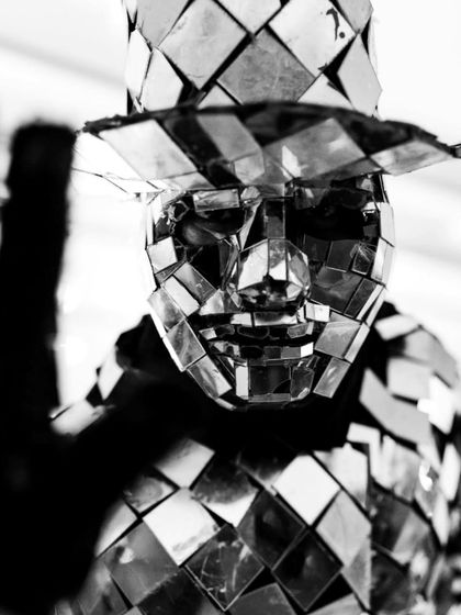 A fun and quirky black and white shot of a performer in a mirrored costume, adding to the unique atmosphere of the party.