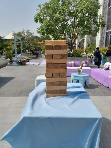 A Giant Jenga tower set up at an outdoor wedding event in Delhi. It provides a relaxed and fun activity for guests to enjoy between ceremonies.