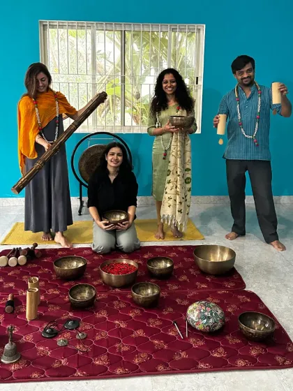 A playful group photo of our Sound Healing graduates with their instruments, including a didgeridoo and various shakers.