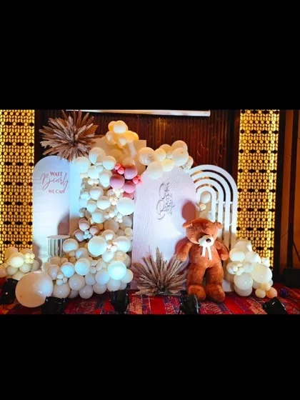 A full view of the main backdrop for the teddy bear baby shower, showing the "We Can Bearly Wait" and "Oh Baby" signs.