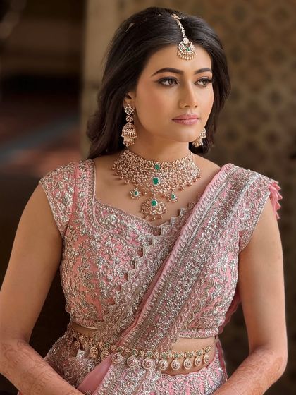 A classic portrait of the bride, showcasing her elegant reception look. The makeup is designed to look stunning in evening light.