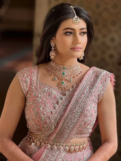 A classic portrait of the bride, showcasing her elegant reception look. The makeup is designed to look stunning in evening light.