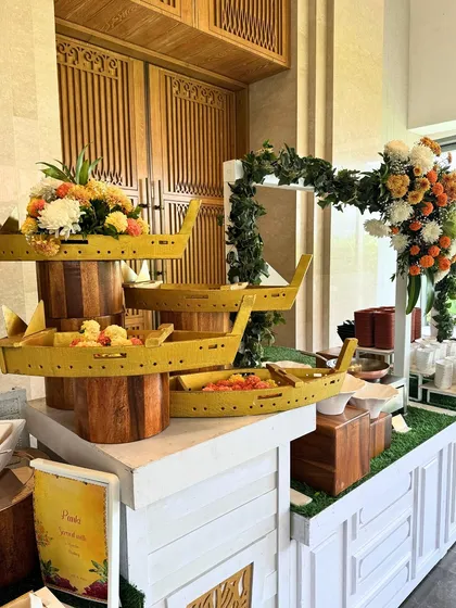 A creative buffet setup featuring boat-shaped serving dishes in a cheerful yellow. This playful yet elegant design adds a unique visual element to the dining experience.
