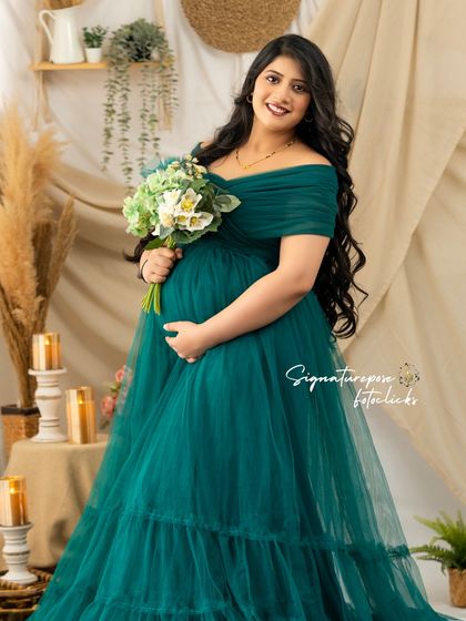 The deep green of the gown provides a beautiful contrast with the neutral tones of the boho set.