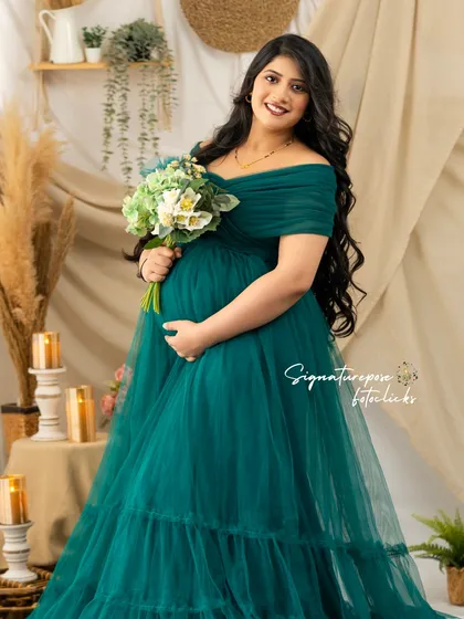 The deep green of the gown provides a beautiful contrast with the neutral tones of the boho set.