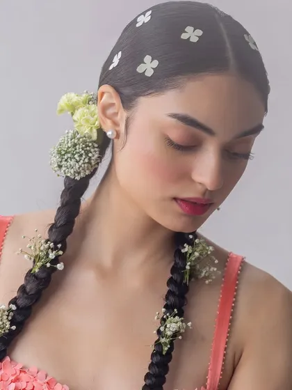 A close-up on the intricate hair and makeup styling for a botanical-themed shoot. I wove small flowers into the model's braids to create a look that feels both organic and meticulously crafted, echoing the theme of a rainforest dreamscape.