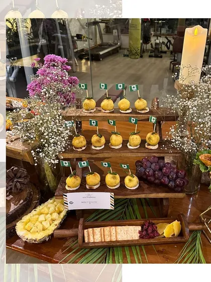 Mini Vada Pavs, maximum flavor. These bite sized delights are arranged on a tiered wooden stand, adorned with mini flags, making them a fun and patriotic snack for a special event.