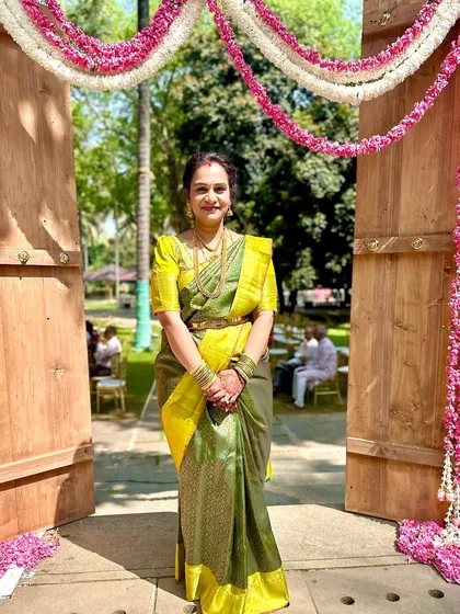 Madhu radiates elegance in this gorgeous silk saree, featuring a striking contrast of yellow and olive green.