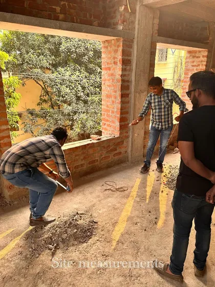 My team taking measurements on a raw construction site.