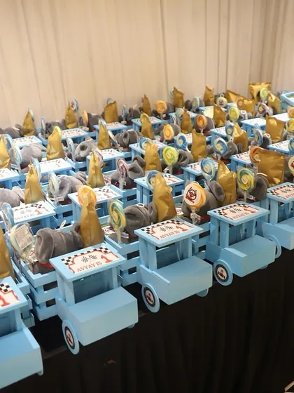 Beep beep! How adorable are these truck-shaped hampers for a first birthday? I loaded these little blue wooden trucks with snacks, lollipops, and a soft elephant toy. It’s a playful return gift that makes all the little guests feel special.