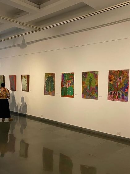 Visitors walking through the gallery space of 'ME, AMMA, WE'.