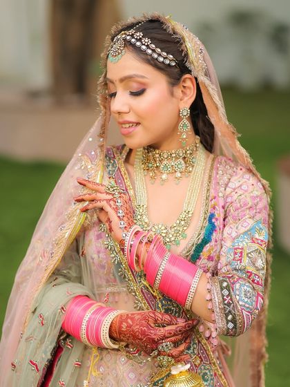 The details of her look, from the pink chooda to the delicate jewelry, all complementing the soft glam makeup.