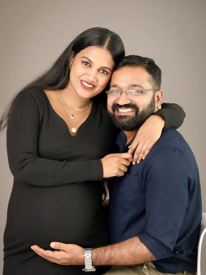 A happy and classic portrait of the parents-to-be. Their smiles show the immense joy and love they share as they prepare for their new arrival.
