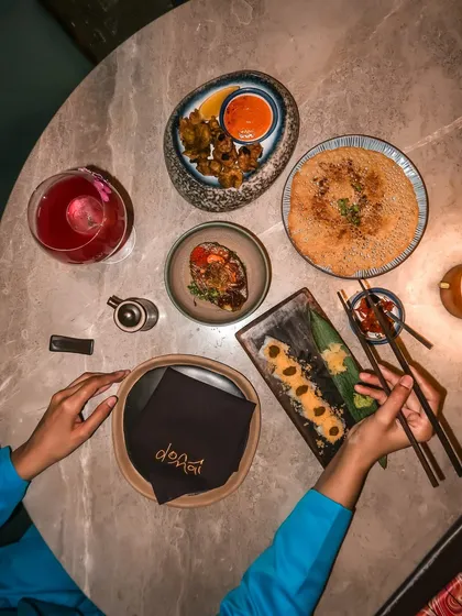 An overhead view of our table spread at Donmai, showcasing a variety of their must-try dishes like Prawn Karaage and Asparagus Uramaki.