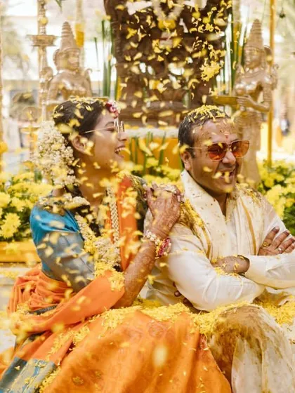 Another angle of the flower shower, capturing the couple's happy expressions as they are covered in petals.