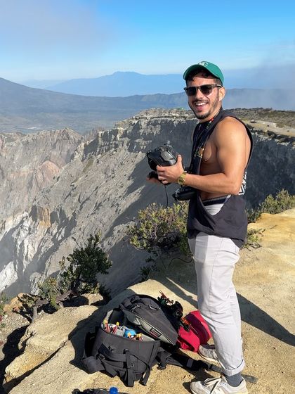 Pausing for a photo on the edge of a massive crater. My gear is my portal to seeing the world with a childlike sense of wonder.