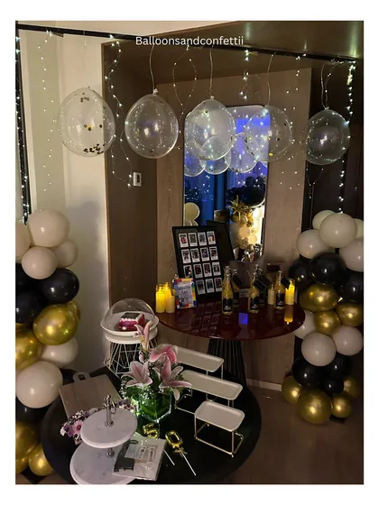 The full dessert and drinks corner for the 50th birthday celebration, with fairy-light bubble balloons and personalized party favors.