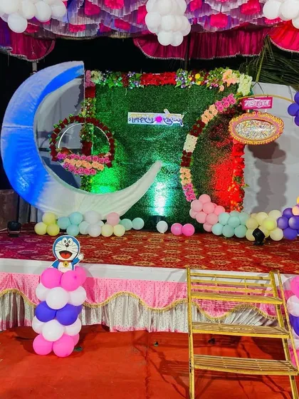 Another view of the whimsical naming ceremony stage, combining different themes like Doraemon and Disney Princess.
