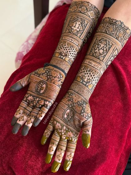 A slightly different angle of Richa's engagement mehendi, highlighting the personalized details and the rich, developing henna stain.