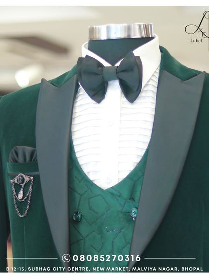 This deep green velvet tuxedo is the definition of luxury. The matching patterned waistcoat, satin lapels, and elegant brooch create a rich, textured look that's perfect for a winter wedding or gala.