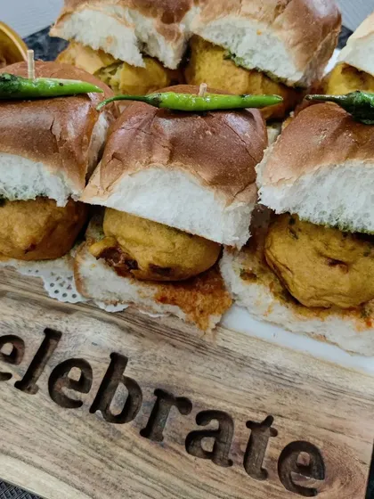 We believe every day is a reason to celebrate, and our mini Vada Pav sliders are the perfect festive snack. Served on a board that says it all, these are a taste of authentic Mumbai street food, made with love.
