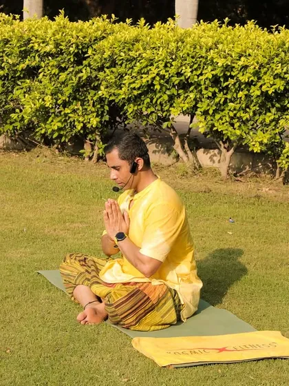 Leading the yoga session with a moment of quiet meditation. A calm mind is just as important as a fit body.