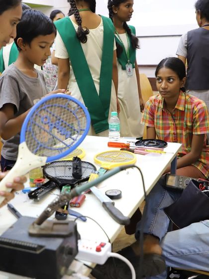 A busy table at our Chennai workshop, with participants of all ages tackling everything from mosquito bats to other household gadgets. The energy of collaborative problem-solving is amazing.