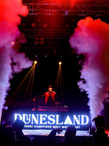 On the decks at Dunesland festival, framed by powerful CO2 jets. I specialize in bringing these high-impact festival effects to any large-scale event.