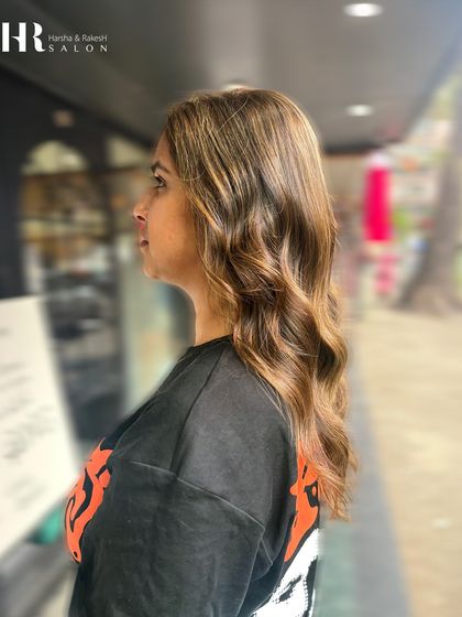 A side view of the caramel balayage, showing how the highlights frame the face and blend into the length.