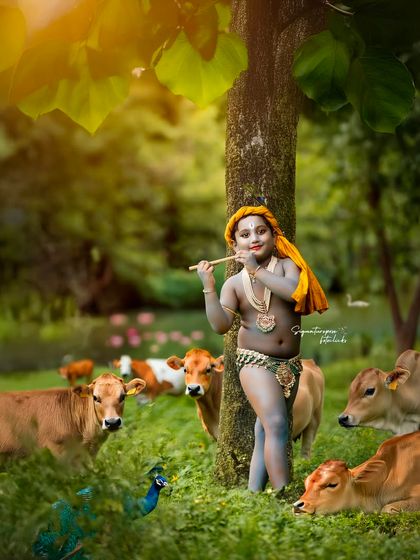 An alternate take from our outdoor Krishna photoshoot, capturing the young boy playing his flute under the shade of a tree, surrounded by nature.
