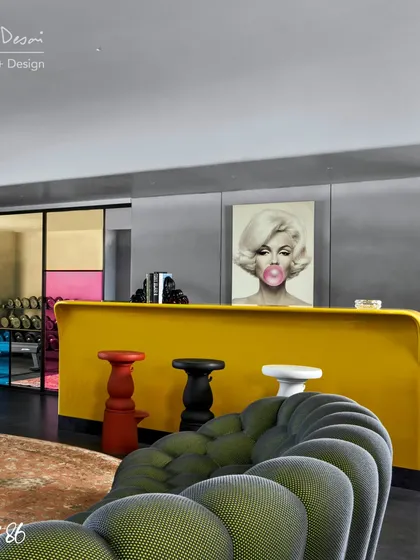 The bar area in Project 86 is defined by a bright yellow counter and colorful Moooi bar stools. The pop art print of Marilyn Monroe adds a playful, glamorous touch to the space.