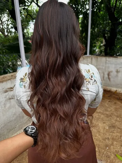 Getting ready for 'Ghar ki shaadi' (a home wedding). This client wanted a glamorous but natural look, so I gave her a rich color melt with soft waves, perfect for the occasion.