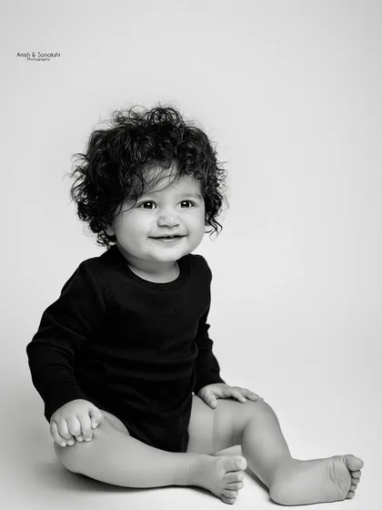 Look at those curls! Sometimes, a simple, classic black and white portrait is all you need to capture the beautiful details of your baby at this age.