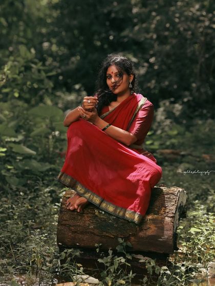 A rustic, village-themed series inspired by the movie 'Kanthara'. The model is styled in a simple red saree, captured in a natural, watery landscape to evoke a sense of raw, earthy beauty.