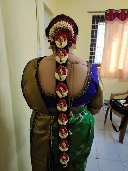 This is an exceptionally detailed floral braid. I used a combination of jasmine, rose petals, and peacock-style floral pieces to create a truly unique and stunning bridal hairstyle.