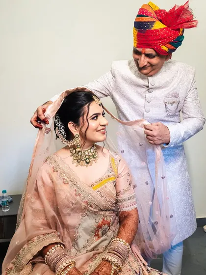 The father putting on the bride's veil, a beautiful and emotional tradition.