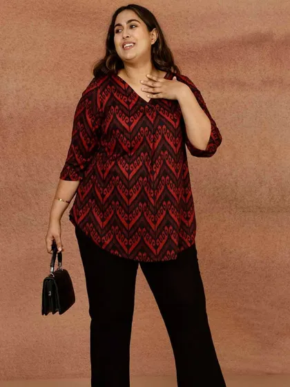 This red and black geometric print top is another great option for a versatile plus-size wardrobe. The V-neck and relaxed fit are designed to be flattering and comfortable for everyday wear.