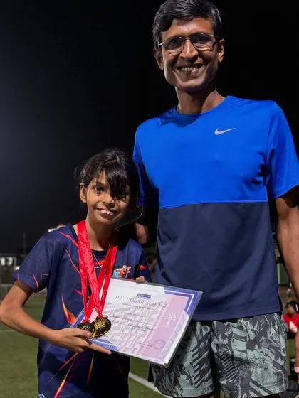 A proud moment between coach and athlete. Kiana Sharma after winning two Gold medals at her school sports day. It's a joy to see her succeed.