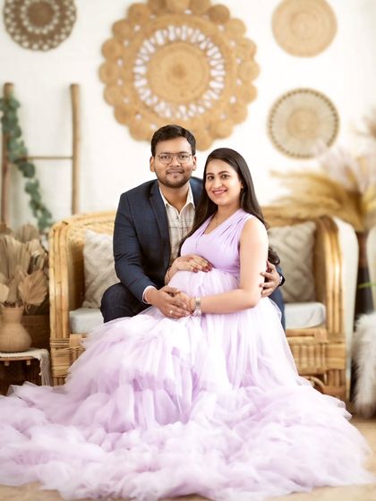 A classic couple's portrait in our boho-chic studio, with both partners sharing a happy and relaxed moment.