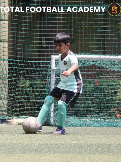A young player from our U7 team showing great focus and technique.